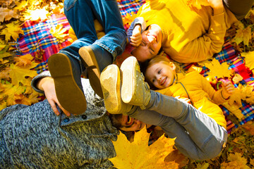 Happy family of forth in autumn park