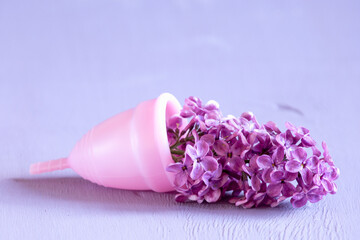 Menstrual cup on violet background. - obrazy, fototapety, plakaty