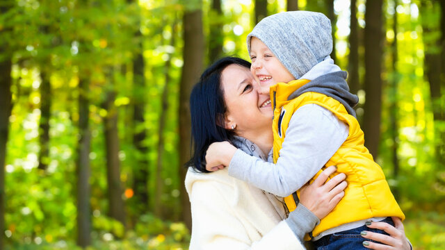 Mother and son have fun in autumn park