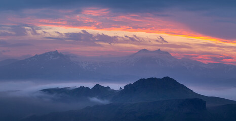 Purple sunset in the mountains. Panorama.