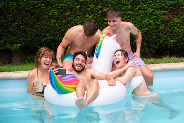 Fototapeta na wymiar Group of people drinking lemonade and taking a selfie in a swimming pool.