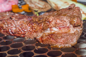  Assorted delicious grilled meat with sausage, sizzling vegetables over the coals, simple Brazilian barbecue concept