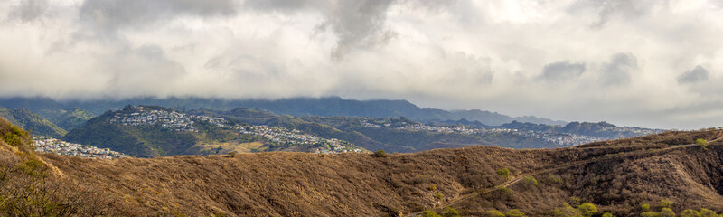 Aerial view of Honolulu, ocean, and foggy mountains from the summit of Diamond Head crater in Oahu,...