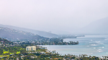 Aerial view of Honolulu, ocean, and foggy mountains from the summit of Diamond Head crater in Oahu, Hawaii