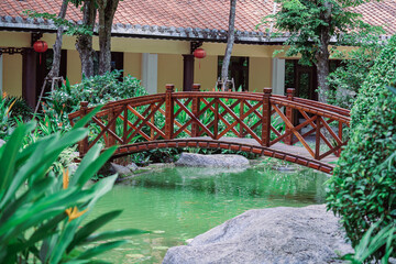 Arched bridge through a decorative pond on a Japanese tropical garden in Danang, Vietnam