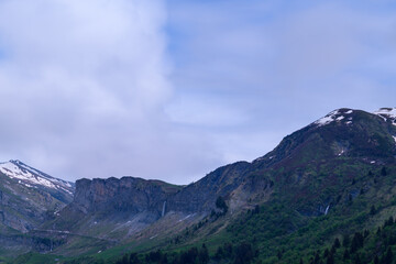 Fototapeta premium The rocky peaks around the Roselend dam in Europe, France, the Alps, towards Beaufort, the Alps, in the summer on a cloudy day.