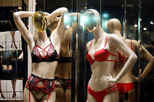 Female mannequins in underwear and swimwear. Lingerie store, red bikini, lace bra and panties with suspenders in a shop