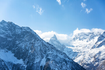 High snow-capped mountains on a sunny day. Magnificent landscape. Active lifestyle and sports.