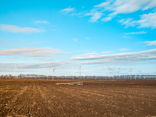 Connecting wind turbines to the grid. Installation of high voltage transmission tower for delivery of green energy concept