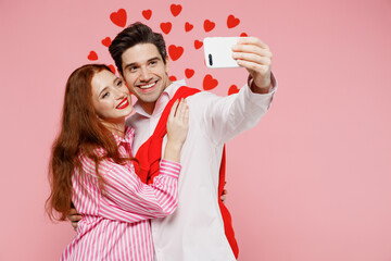 Young couple two friends woman man 20s in casual shirt doing selfie shot on mobile cell phone isolated on plain pastel pink background studio portrait. Valentine's Day birthday holiday party concept.