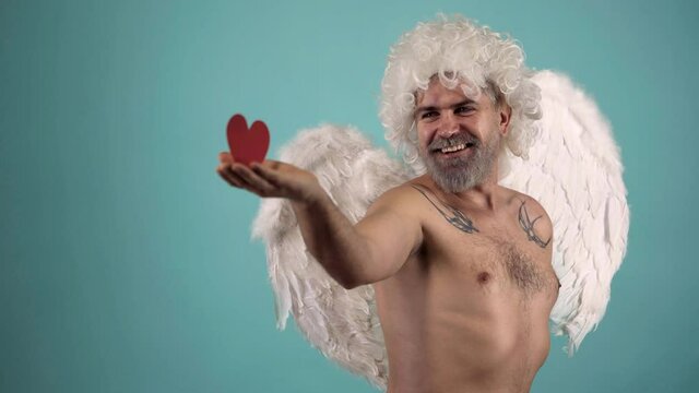 Valentines Day. Crazy bearded angel man with heart. Valentin angel man with wings. Funny Valentines day celebration.