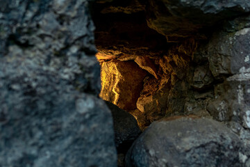 embrasure in the old fortress wall through which light breaks, close-up