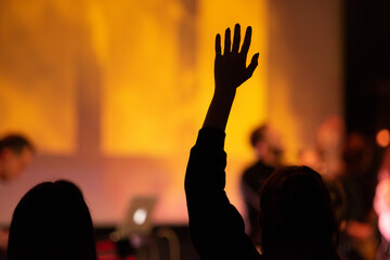 Hands in the air of people who praise God at church service - 478373613