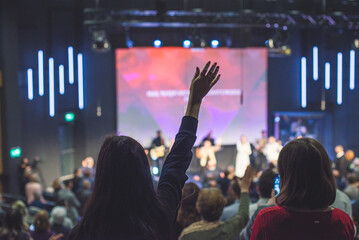 Hands in the air of people who praise God at church service - 478373616