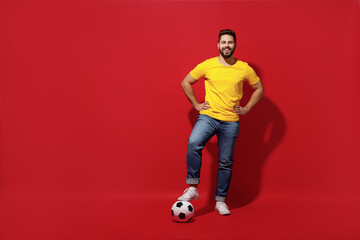 Full size body length happy young bearded man football fan in yellow t-shirt cheer up support...