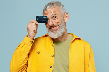 Elderly smiling happy fun gray-haired mustache bearded man 50s wear yellow shirt hold in hand cover...