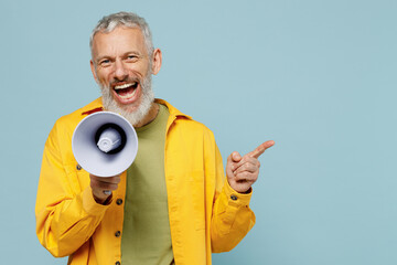 Elderly happy gray-haired mustache bearded man 50s in yellow shirt hold scream in megaphone...
