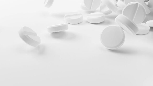 White antibiotic pills or tablets falling onto heap in slow motion, pharmacy, medication or drug concept
