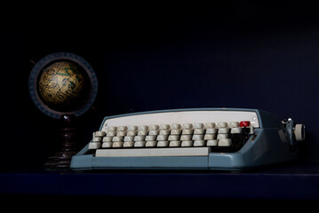 Closeup view of type writer and old world map