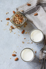 Healthy breakfast, yogurt parfait. Yogurt with homemade almond granola on a gray concrete background. Top view flat lay.