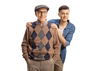 Grandson standing behind his grandfather and smiling