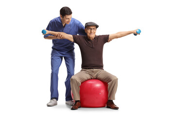 Physical therapist working with an elderly man doing exercise on a fitness ball