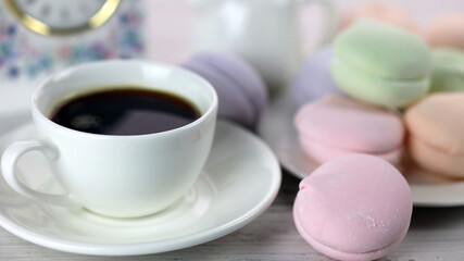 a cup of coffee and colorful natural delicious marshmallows for breakfast