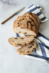 Sliced sourdough bread with raisins and rye flour. Healthy home baking and artisanal bread concept.