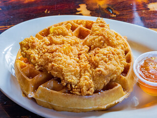 Close up shot of deep fried chicken with waffle