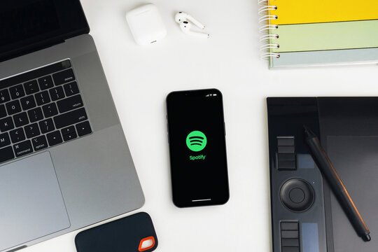 Spotify music app on the smartphone screen on white background table. Office environment. Rio de Janeiro, RJ, Brazil. January 2022