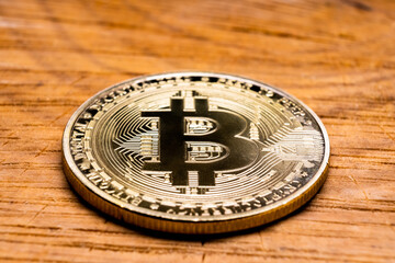 Crypto Coin Bitcoin close-up on a wooden table.