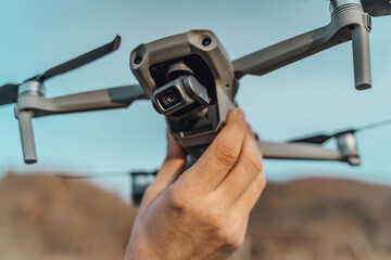 A man holding a drone in his hand ready to fly