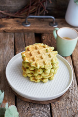 Belgian avacado waffles. Side view, wooden background. Rustic. 
