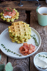 Belgian avocado waffles with salmon. Side view, wooden background. Rustic. 