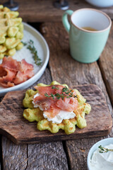 Belgian avocado waffles with salmon. Side view, wooden background. Rustic. 