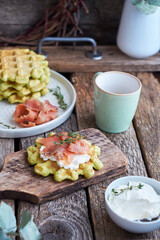 Belgian avocado waffles with salmon. Side view, wooden background. Rustic. 
