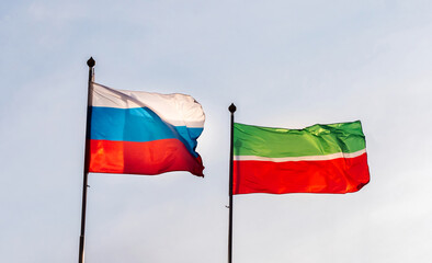 Fototapeta na wymiar Flag of Russia and flag of the Republic of Tatarstan against the sky. Waving flags