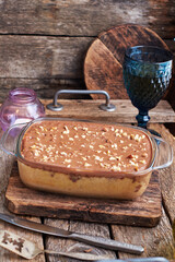 homemade chocolate cake with nuts, side view, wooden background.