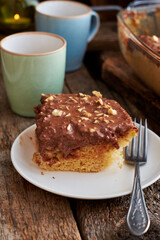 homemade chocolate cake with nuts, side view, wooden background.