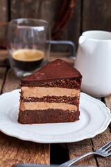 piece of cake with coffee on a wooden background, side view