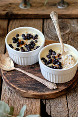 Baked porridge with cream and blueberries.Side view, wooden background