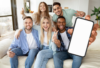 Diverse people showing white empty smartphone screen and gesturing yes