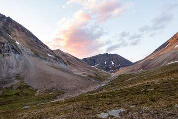 High above the tree line in  Alaska's Northern Talkeetna Mountains the mid-summer light is...
