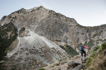 Naklejka na ściany i meble A Lone Woman Trekking In The Alps