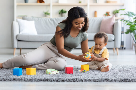 Happy African American Family, Mom And Infant Child Playing Together At Home