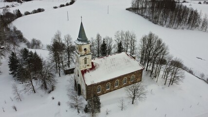 Lutheran church amid fluffy white snow in the Latvian village of Remte on December 29, 2021
