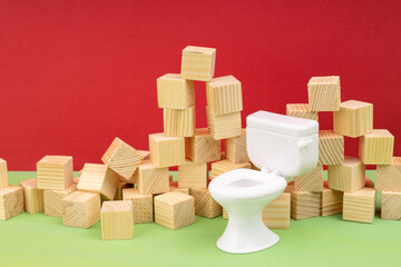 lots of randomly arranged wood cubes and a white toilet