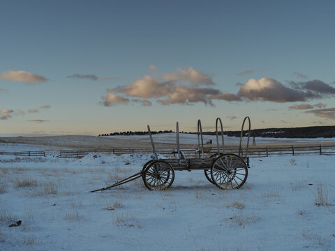 old wagon in frozen prairie at sunrise