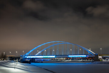 Fototapeta na wymiar Night illumination of the bridge across Ishim river in Nur-Sultan, Kazakhstan.