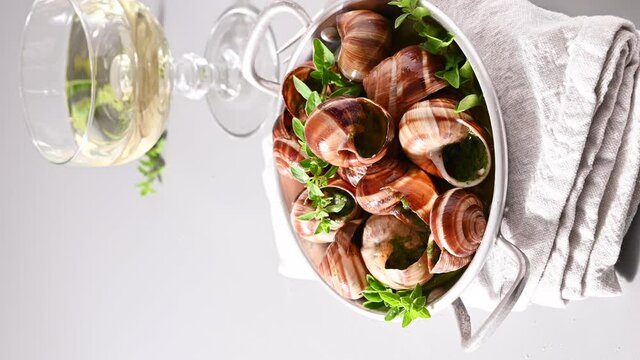 Grilled snails , cooking barbecue seafood with pesto sauce. French cuisine. Vertical video, ideal for social media and smartphones. 4 k